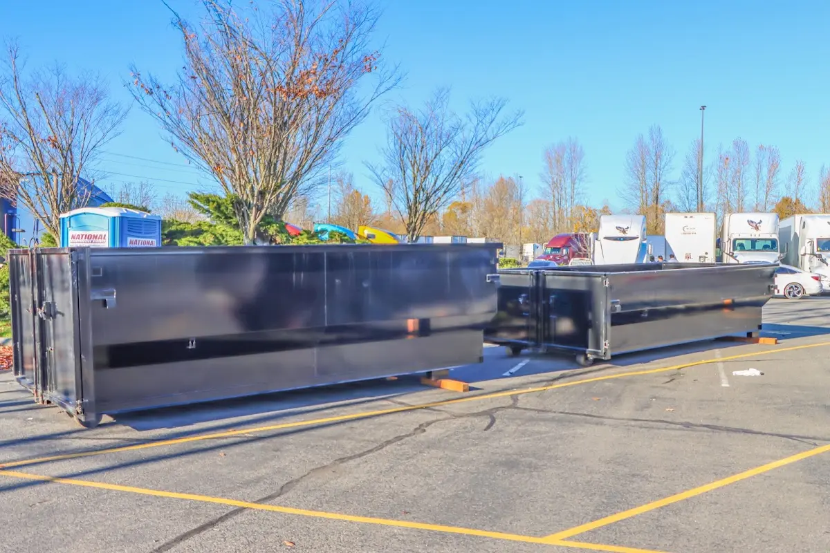 Professional dumpster rental service with roll-off container on residential driveway in Colchester